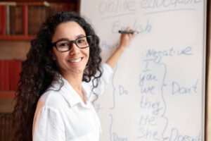 female esl teacher at white board