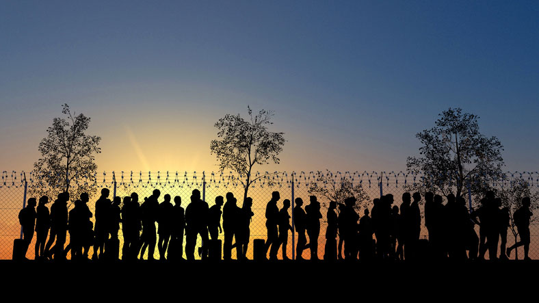 migrants at border fence